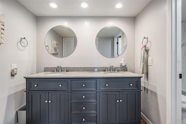 full bathroom with recessed lighting, a sink, baseboards, and double vanity