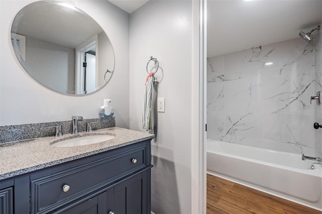 full bath with shower / bathtub combination, wood finished floors, and vanity