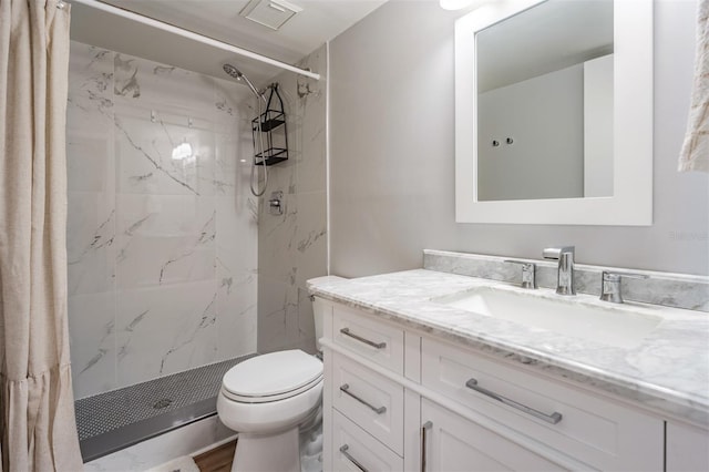 full bathroom featuring toilet, a stall shower, visible vents, and vanity