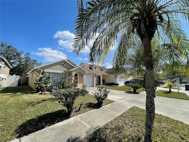 view of front of house with a garage and a front lawn