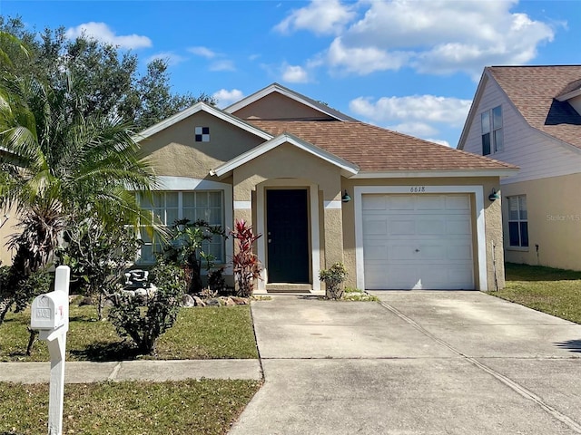 view of front of home featuring a front yard and a garage