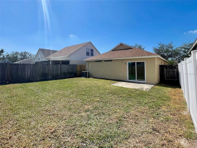 rear view of property with a patio, a yard, and central AC unit