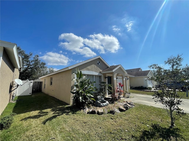 view of side of property featuring a yard