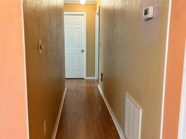 hallway with hardwood / wood-style floors