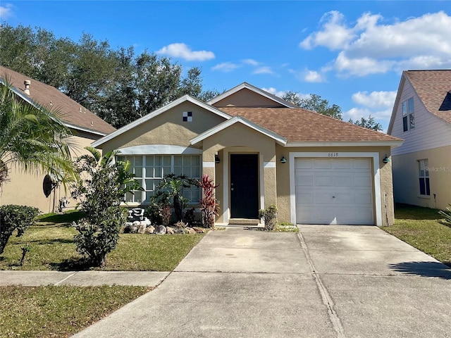 view of front of home featuring a garage and a front yard