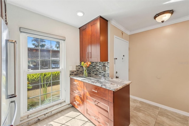 kitchen with tasteful backsplash, ornamental molding, and light stone countertops