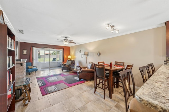 dining area with ornamental molding, light tile patterned floors, and ceiling fan