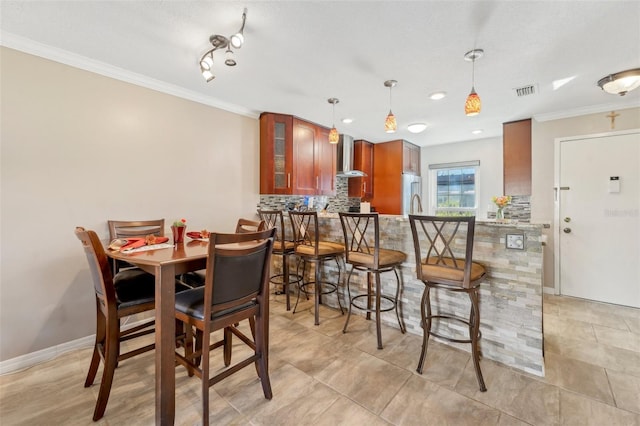 dining room featuring ornamental molding