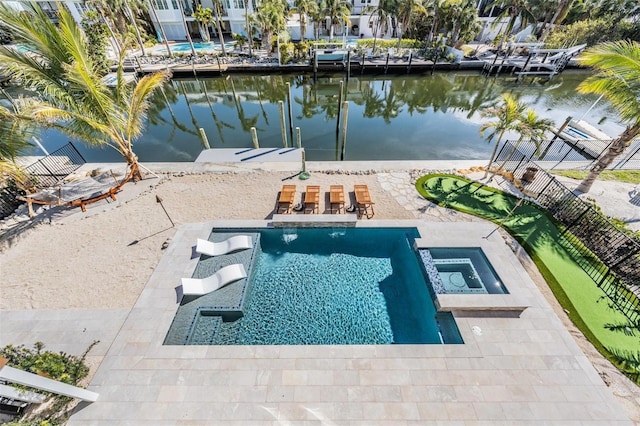 view of pool featuring a patio area, an in ground hot tub, and a water view