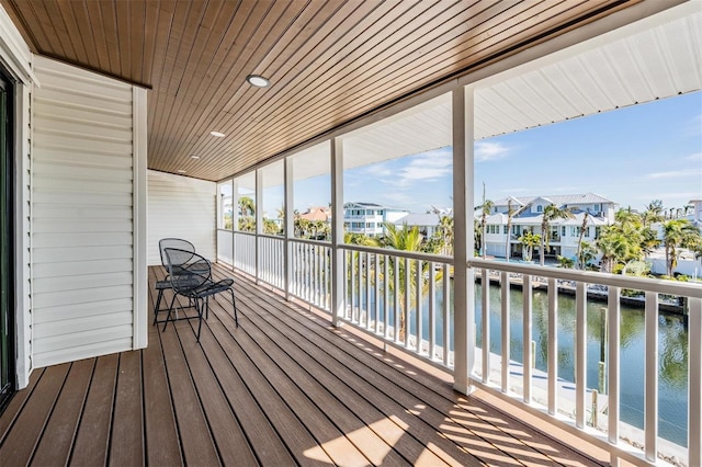 wooden deck featuring a water view