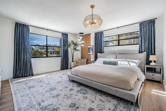 bedroom featuring multiple windows and light wood-type flooring