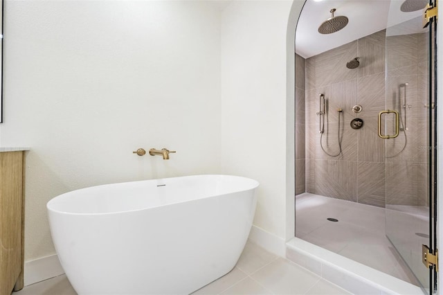 bathroom with tile patterned floors and separate shower and tub