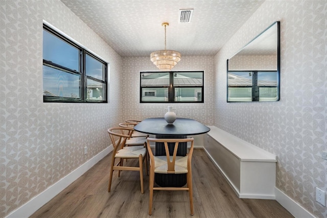 dining area with breakfast area, hardwood / wood-style floors, and a wealth of natural light