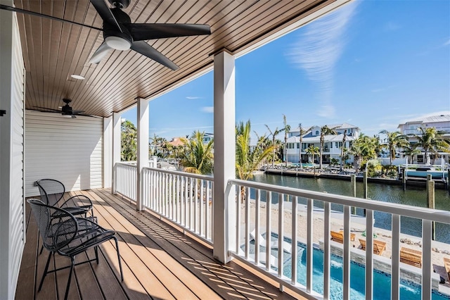 deck featuring a water view and ceiling fan