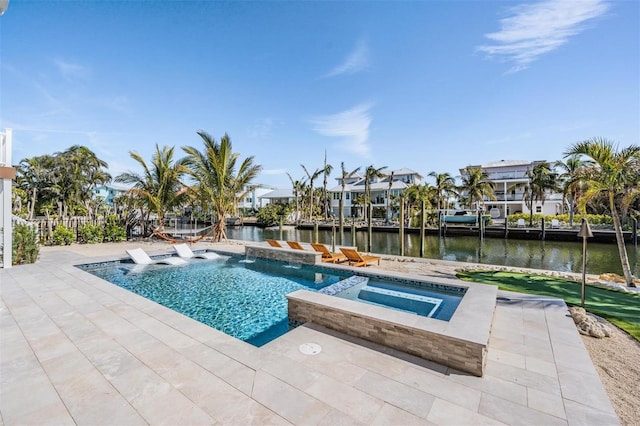 view of pool featuring an in ground hot tub, a water view, pool water feature, and a patio