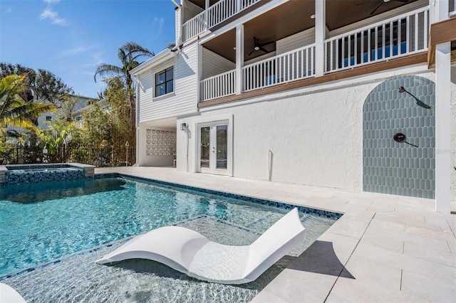 view of swimming pool with an in ground hot tub, ceiling fan, a patio area, and french doors