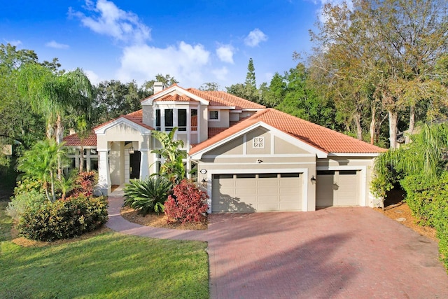 mediterranean / spanish-style home with a garage