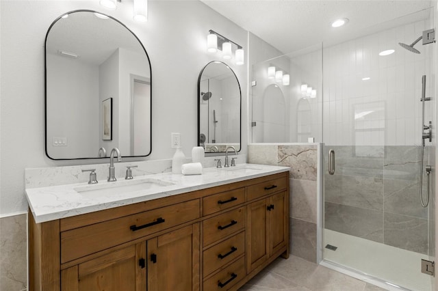 bathroom featuring vanity, tile patterned floors, and walk in shower