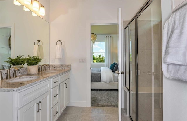 bathroom with a shower with door and vanity