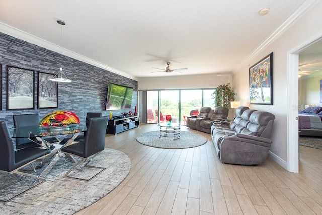 living room with ornamental molding, ceiling fan, and light wood-type flooring