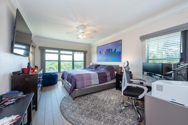 bedroom featuring crown molding, ceiling fan, and hardwood / wood-style floors