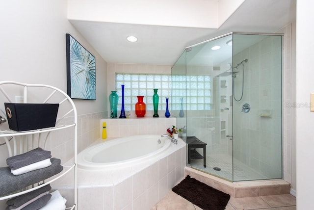 bathroom featuring plus walk in shower and tile patterned flooring