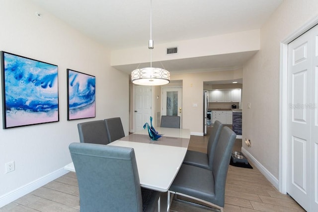 dining space with light wood-type flooring