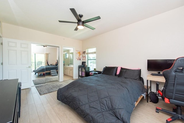 bedroom with ensuite bath, light hardwood / wood-style flooring, and ceiling fan