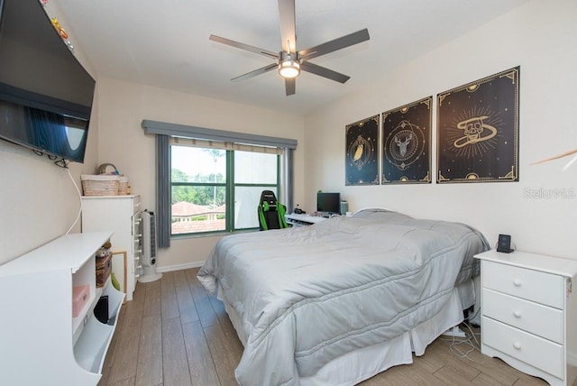 bedroom featuring ceiling fan and light hardwood / wood-style floors