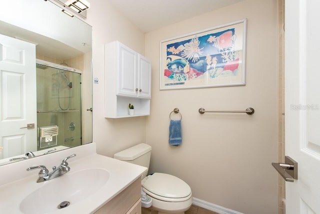 bathroom featuring vanity, an enclosed shower, and toilet