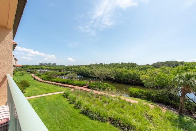 view of yard with a balcony and a water view