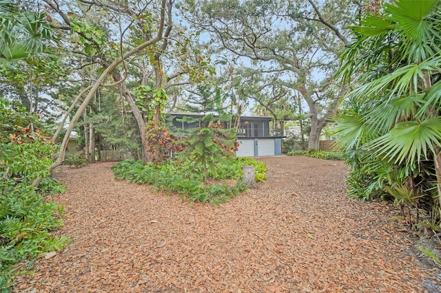 view of yard with a garage and a sunroom