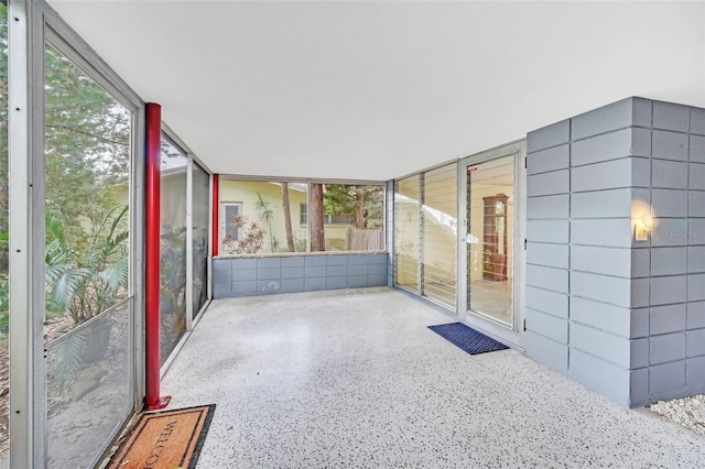 unfurnished sunroom featuring a wealth of natural light