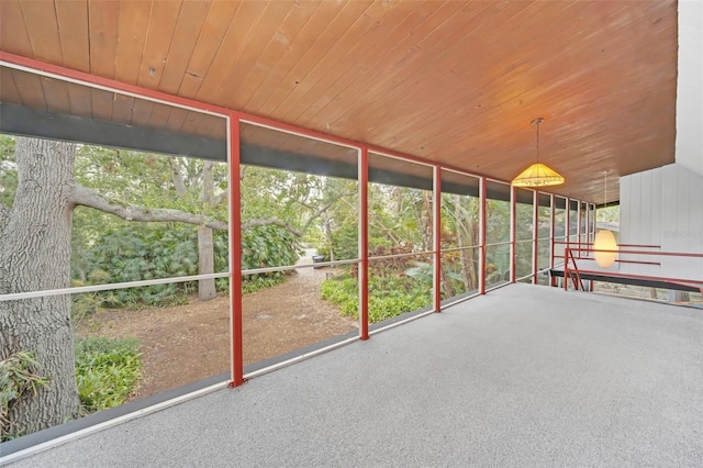 unfurnished sunroom with wood ceiling