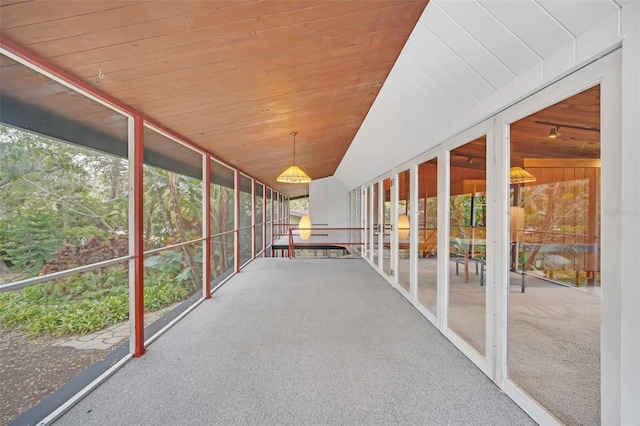 unfurnished sunroom featuring wooden ceiling