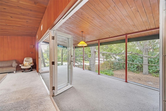 unfurnished sunroom featuring wooden ceiling