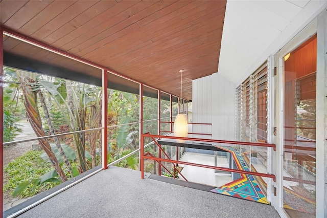 unfurnished sunroom with wood ceiling