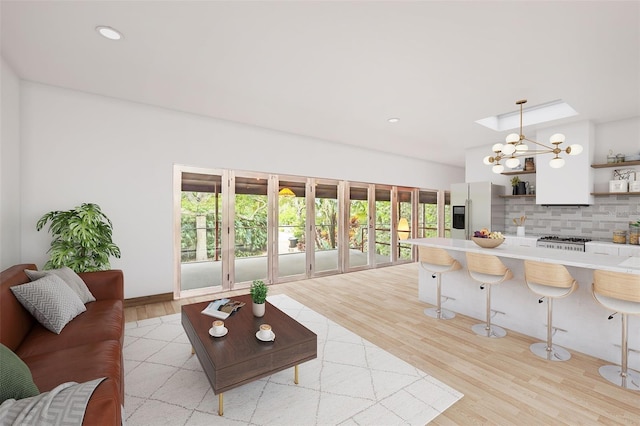 living room with an inviting chandelier and light hardwood / wood-style floors