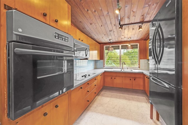 kitchen with pendant lighting, sink, decorative backsplash, black appliances, and wooden ceiling