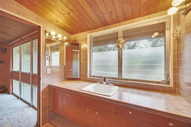 bathroom with lofted ceiling, wood ceiling, and a wealth of natural light