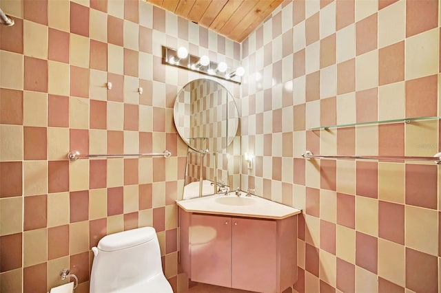 bathroom with tasteful backsplash, vanity, tile walls, and toilet