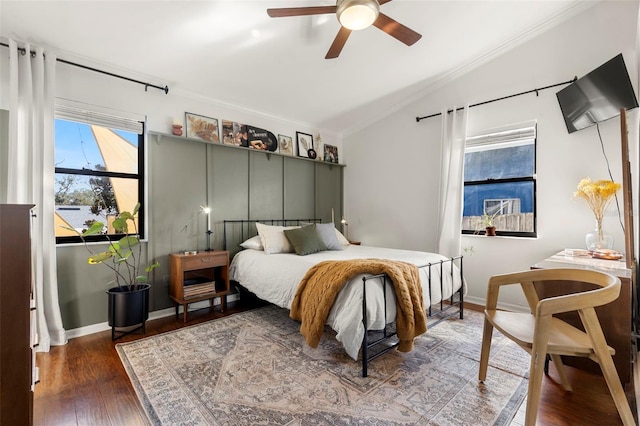 bedroom with crown molding, ceiling fan, lofted ceiling, and dark wood-type flooring