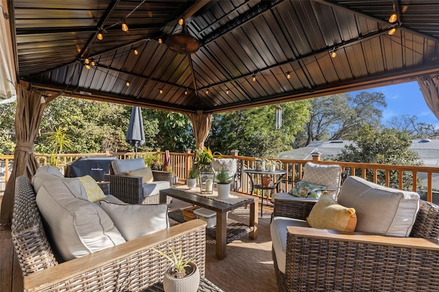 wooden deck with a gazebo and outdoor lounge area