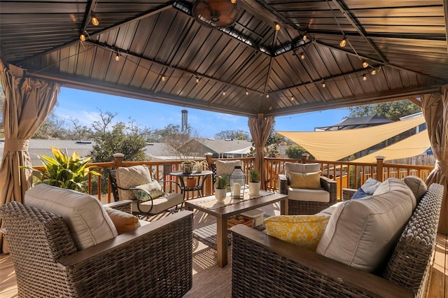 exterior space with an outdoor living space, a gazebo, and a deck