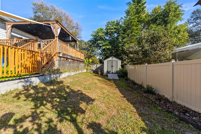 view of yard featuring a deck and a storage unit