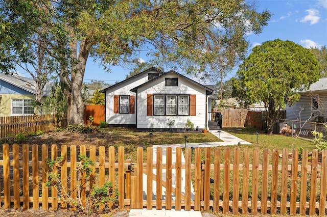 bungalow-style home with a front lawn