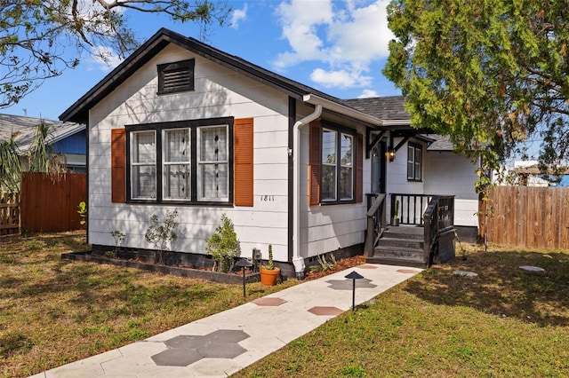 bungalow-style home featuring a front lawn