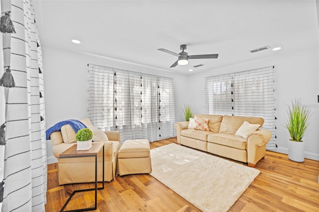 living room featuring ceiling fan and light wood-type flooring