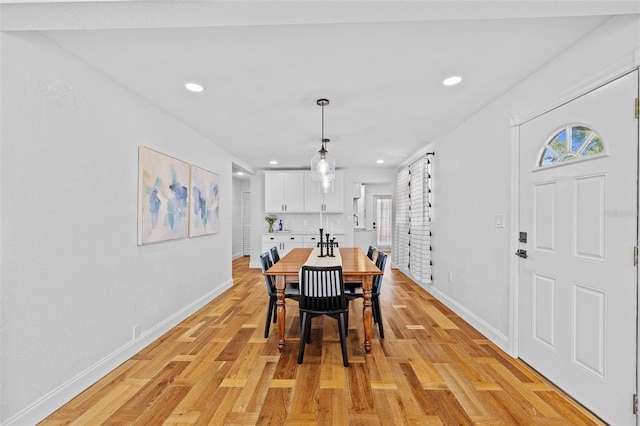 dining room with light hardwood / wood-style flooring and a wealth of natural light