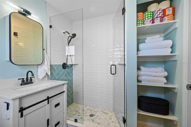 bathroom with vanity and a shower with shower door